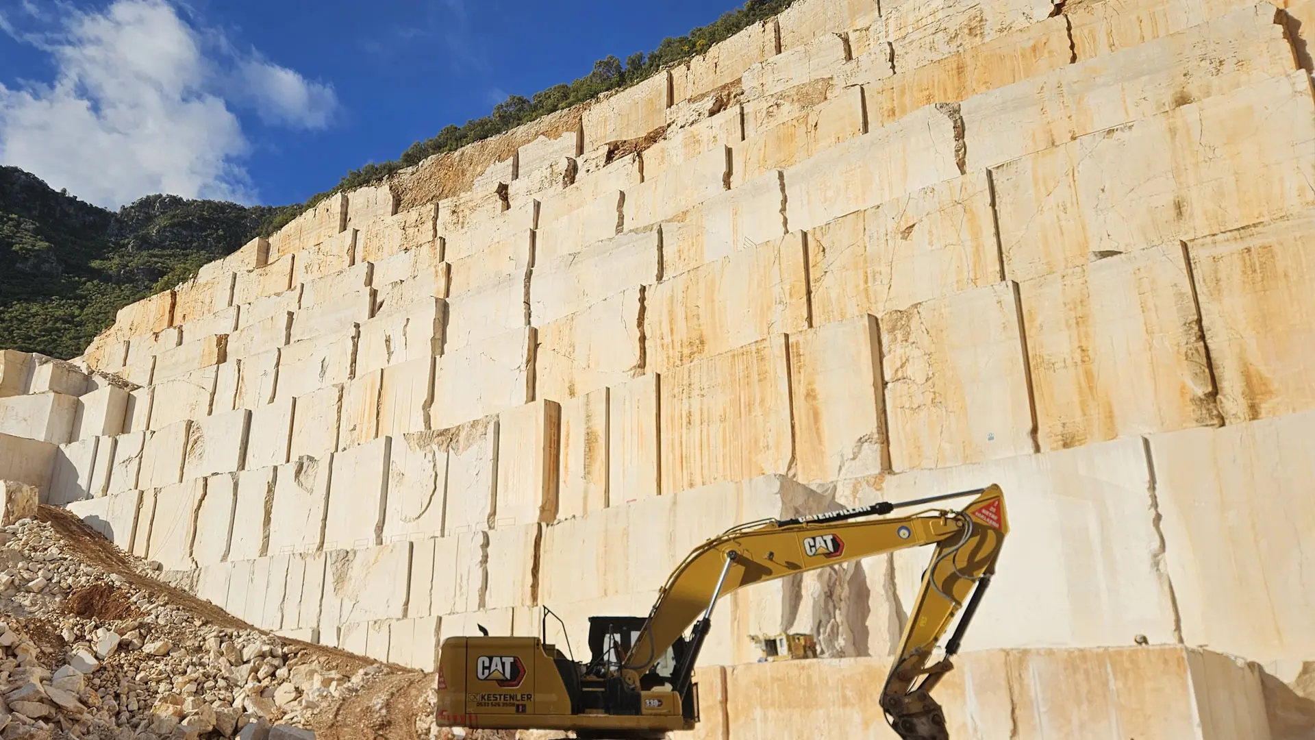 Active limestone quarry showing exposed sedimentary layers and extraction face