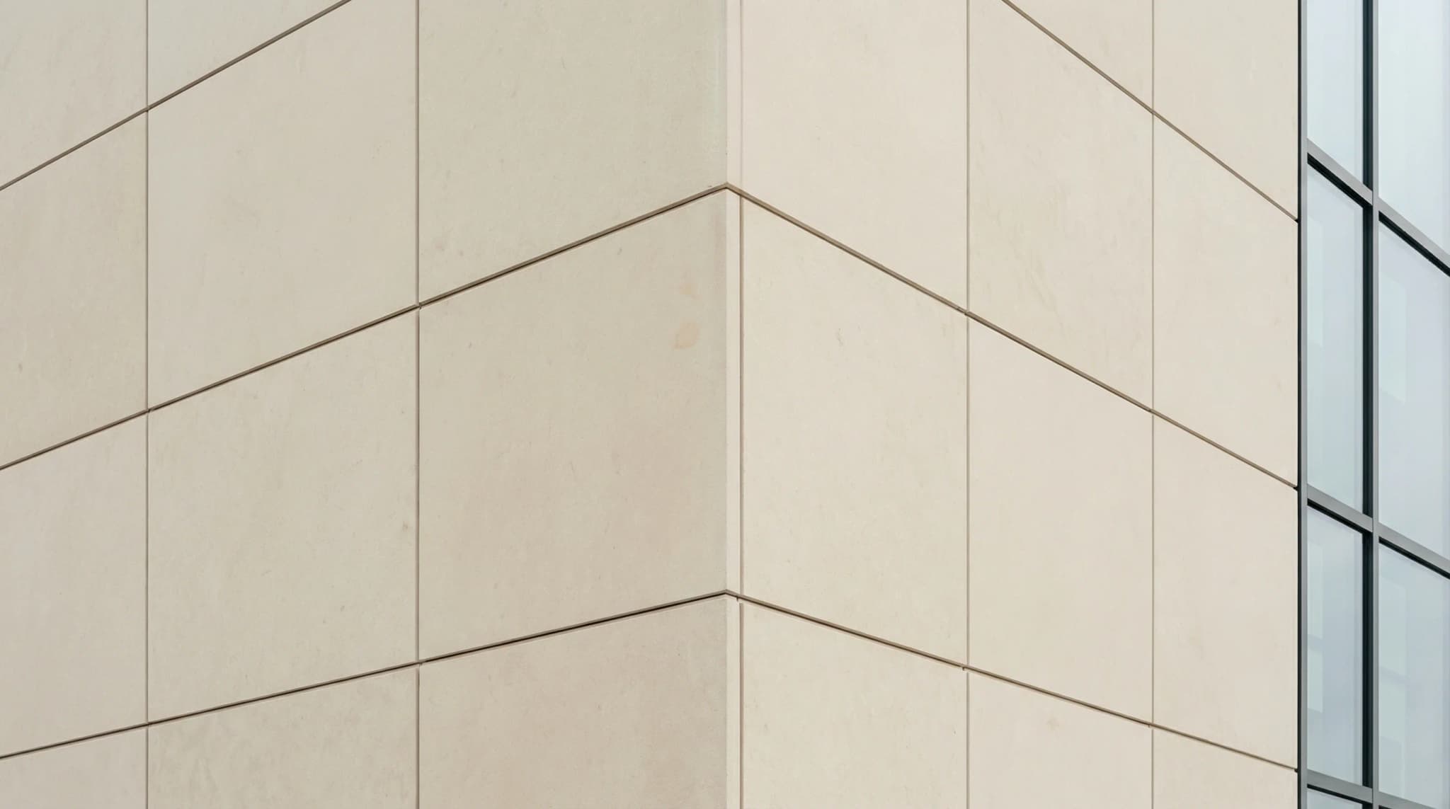 Architectural detail of modern building facade clad in dense uniform Turkish limestone panels