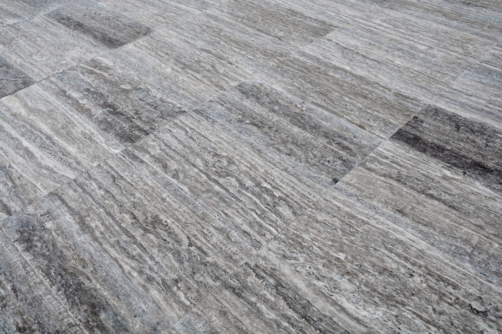 Vein-Cut Silver Travertine flooring with grey tones and natural veining pattern, matte finish Vein-Cut Silver Travertine flooring with grey tones and natural veining pattern, matte finish