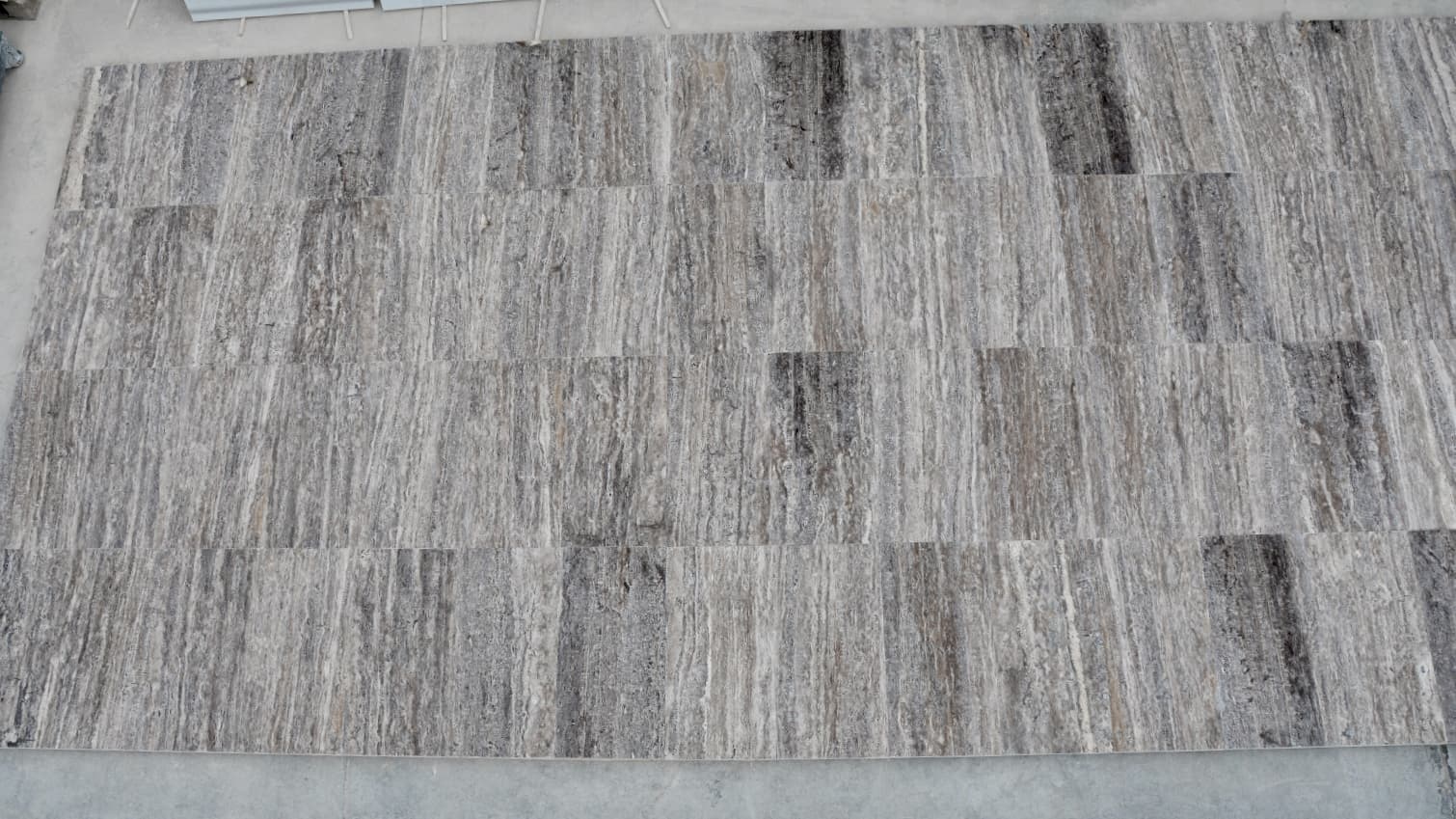 Vein-Cut Silver Travertine flooring tiles displaying grey tones with natural linear veining patterns and matte finish Vein-Cut Silver Travertine flooring tiles displaying grey tones with natural linear veining patterns and matte finish