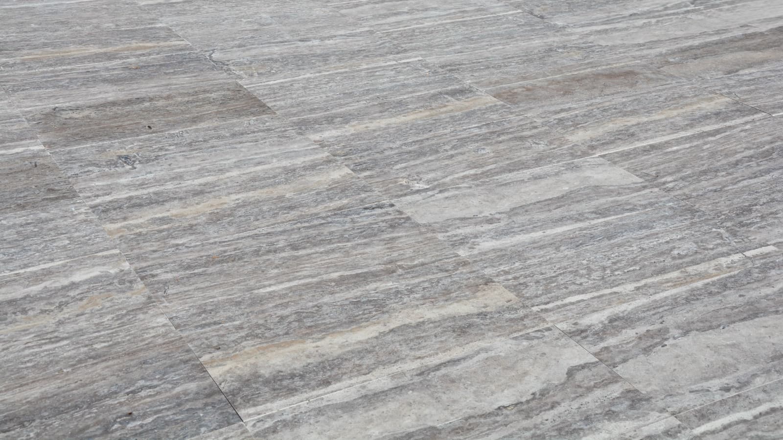 Vein-Cut Silver Travertine flooring with grey tones and natural veining pattern in matte finish Vein-Cut Silver Travertine flooring with grey tones and natural veining pattern in matte finish