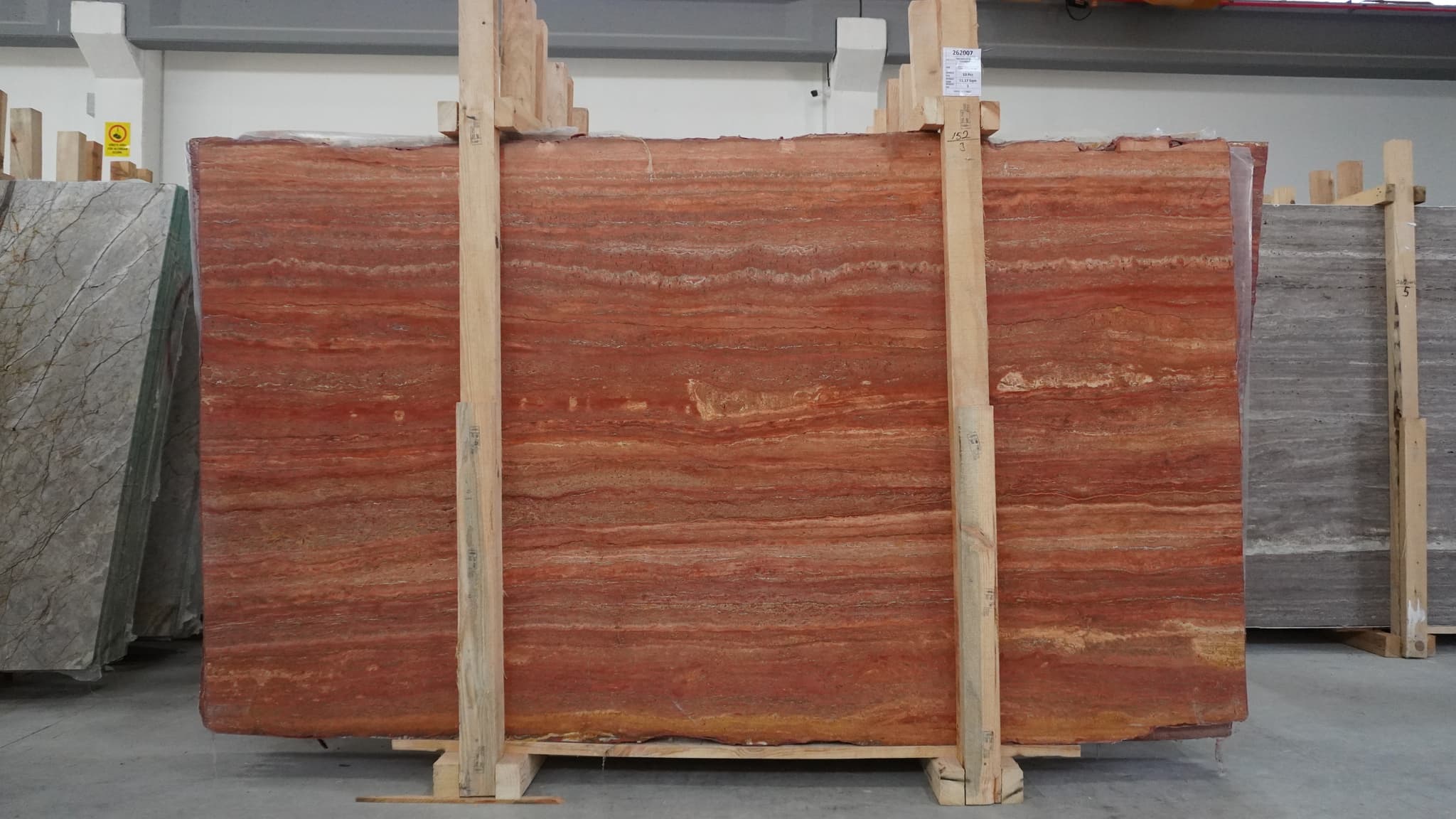 Persian Red Travertine slabs in a wooden bundle — original material reference photograph Persian Red Travertine slabs in a wooden bundle — original material reference photograph