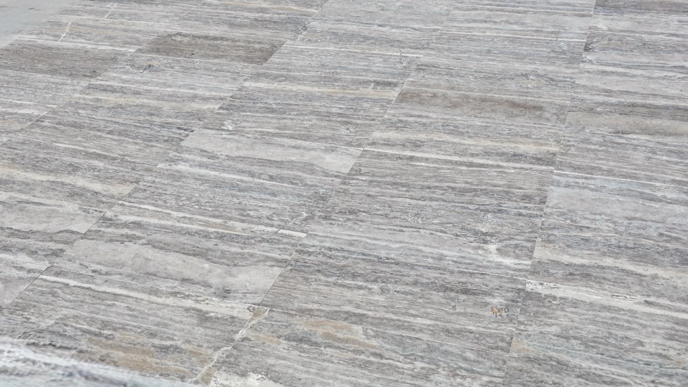 Vein-Cut Silver Travertine gallery image showing grey stone with linear vein patterns and matte finish Vein-Cut Silver Travertine gallery image showing grey stone with linear vein patterns and matte finish